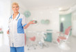 Mature doctor shows welcome gesture