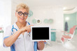 Mature doctor with funny glasses and tablet PC