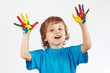 Foto: Young boy with painted hands on a white background Young boy with painted hands on a white background