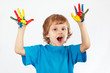 Foto: Joyful boy with painted hands on a white background Joyful boy with painted hands on a white background