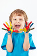 Foto: Playful boy with painted hands on a white background Playful boy with painted hands on a white background
