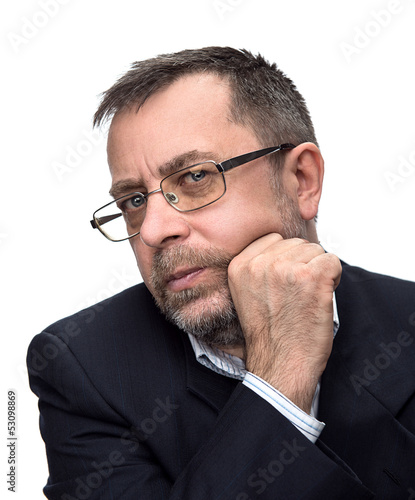 Photo: Senior businessman thinking with his hand at the chin. Senior businessman thinking with his hand at the chin.