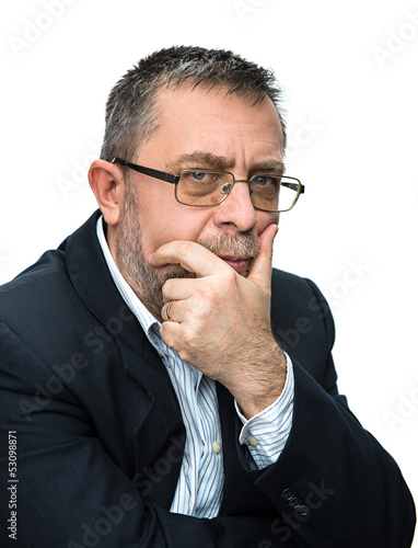 Photo: Senior businessman thinking with his hand at the chin. Senior businessman thinking with his hand at the chin.