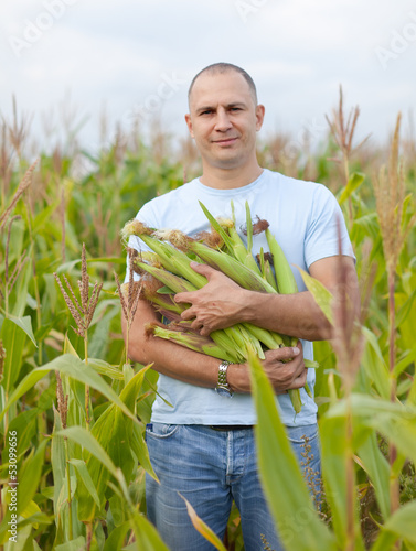 Photo: farmer in field of corn farmer in field of corn
