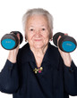 Happy old woman making fitness training with dumbbells