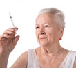 Old  woman preparing syringe for making insulin injection