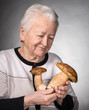 Old woman looking at mushrooms