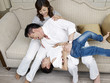 family having fun on couch at home