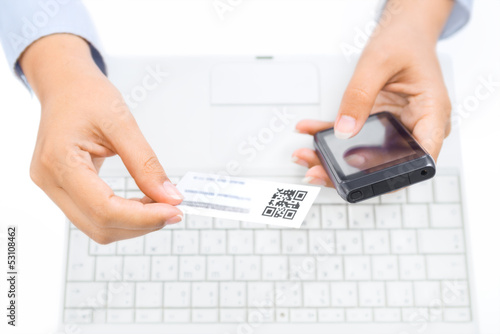 Photo: Hands holding smart phone and business card with qr code Hands holding smart phone and business card with qr code