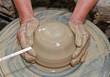 Close-up of hands making pottery on pottery wheel