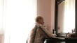 Pensive mature woman looking into a mirror