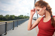 Beautiful woman after fitness training on bridge
