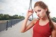 Photo: Beautiful woman after fitness training on bridge Beautiful woman after fitness training on bridge