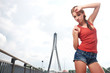Photo: Beautiful woman after fitness training on bridge Beautiful woman after fitness training on bridge