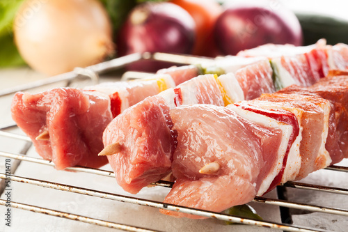Photo: Raw shashlik on grill Raw shashlik on grill