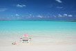 Girl in a striped hat on the beach of Exuma, Bahamas