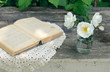 Dog rose flowers in a glass on rusted wooden table