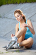 Roller skate girl skating. Young woman putting on skates going r