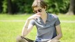 young beautiful hipster woman reading book in the park