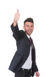 Positive young businessman gives thumbs up gesture