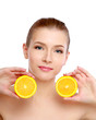 Young brunette woman with oranges in her hands