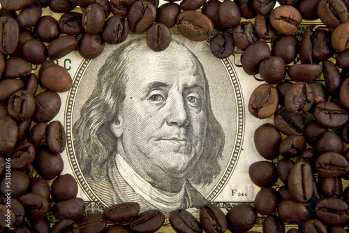 Photo: dollar and grains of coffee as a scope dollar and grains of coffee as a scope