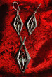 silver earrings and pendent with the image of a dragon on red