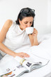 Woman reading and drinking coffee on bed