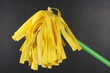 Yellow mop for floor on gray background