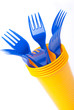 Bright plastic tableware, cups and forks on white background, se