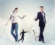 Businesspeople with marionettes