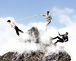 Three business people pulling rope