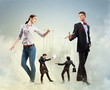Businesspeople with marionettes