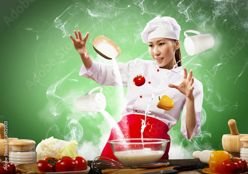Photo: Asian female cooking with magic Asian female cooking with magic