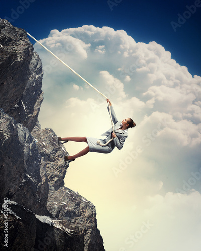 Photo: businesswoman climbing mountain businesswoman climbing mountain