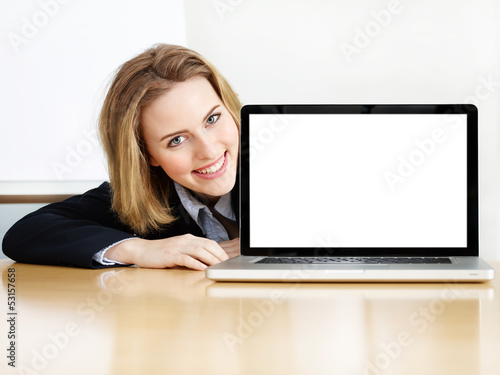 Photo: Business woman presenting her laptop with copyspace Business woman presenting her laptop with copyspace