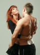 Foto: Sexy passionate young couple hugging on grey isolated background Sexy passionate young couple hugging on grey isolated background