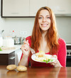 Casual  girl eating jacket potatoes