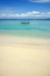 Tropical beach with clear water and boat
