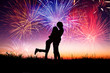 Foto: loving young couple with fireworks background loving young couple with fireworks background
