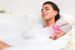 beautiful young woman takes bubble bath