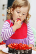 girl eating a strawberry