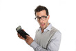 Worried man showing bad figures on calculator