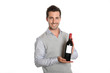 Happy winegrower showing wine bottle to camera