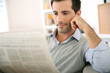Photo: Man at home reading newspaper Man at home reading newspaper