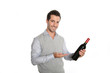 Happy winegrower showing wine bottle to camera