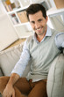 Handsome man relaxing in sofa at home
