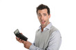 Worried man showing bad figures on calculator