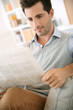 Photo: Man at home reading newspaper Man at home reading newspaper
