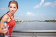 Young woman drinking water at outdoors workout